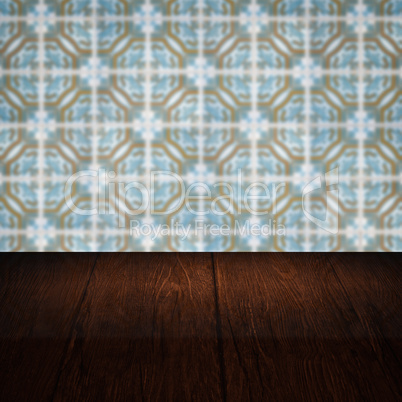 Wood table top and blur vintage ceramic tile pattern wall