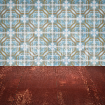 Wood table top and blur vintage ceramic tile pattern wall