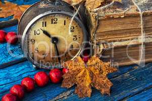 old-fashioned alarm clock and coral beads