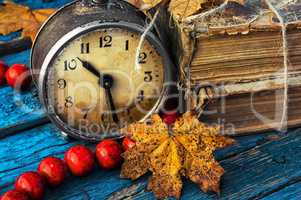 old-fashioned alarm clock and coral beads