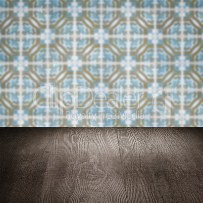 Wood table top and blur vintage ceramic tile pattern wall