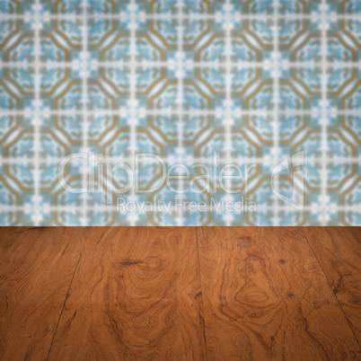 Wood table top and blur vintage ceramic tile pattern wall