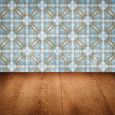 Wood table top and blur vintage ceramic tile pattern wall