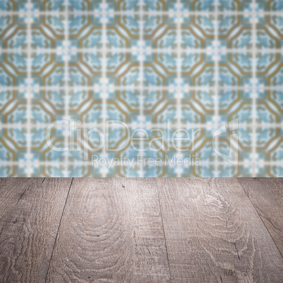 Wood table top and blur vintage ceramic tile pattern wall