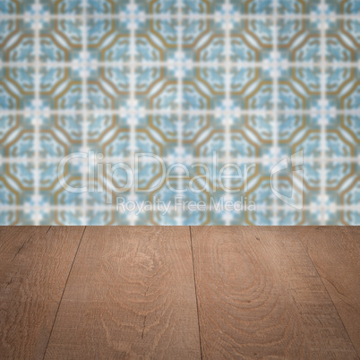 Wood table top and blur vintage ceramic tile pattern wall