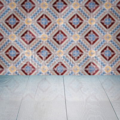 Wood table top and blur vintage ceramic tile pattern wall