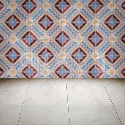 Wood table top and blur vintage ceramic tile pattern wall