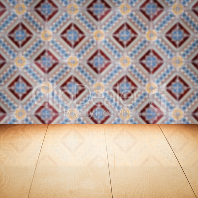 Wood table top and blur vintage ceramic tile pattern wall