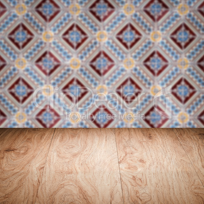 Wood table top and blur vintage ceramic tile pattern wall