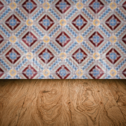 Wood table top and blur vintage ceramic tile pattern wall