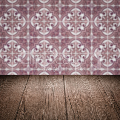 Wood table top and blur vintage ceramic tile pattern wall