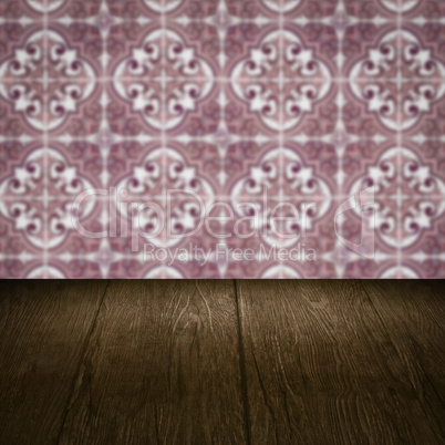 Wood table top and blur vintage ceramic tile pattern wall Wood table top and blur vintage ceramic tile pattern wall