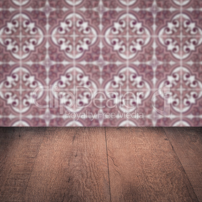 Wood table top and blur vintage ceramic tile pattern wall