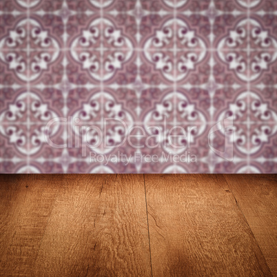 Wood table top and blur vintage ceramic tile pattern wall