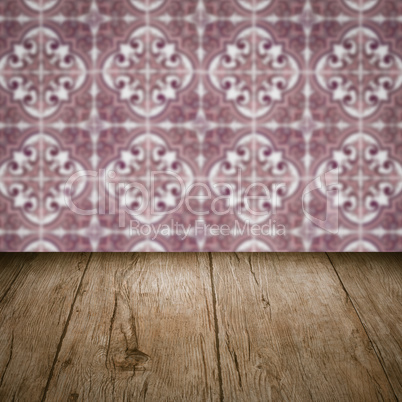 Wood table top and blur vintage ceramic tile pattern wall