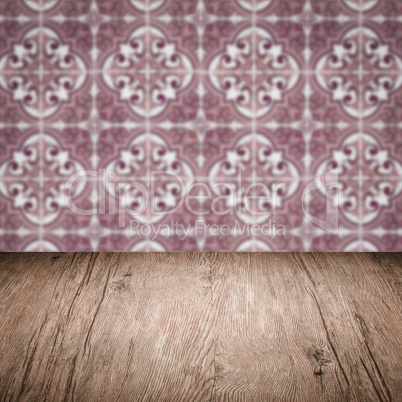 Wood table top and blur vintage ceramic tile pattern wall