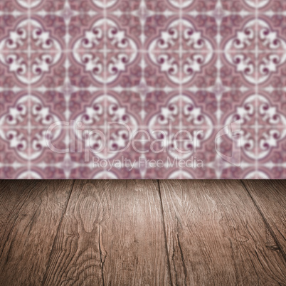 Wood table top and blur vintage ceramic tile pattern wall