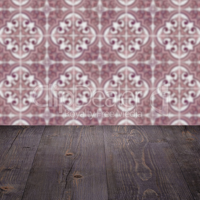 Wood table top and blur vintage ceramic tile pattern wall