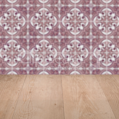 Wood table top and blur vintage ceramic tile pattern wall