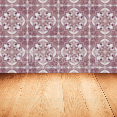 Wood table top and blur vintage ceramic tile pattern wall