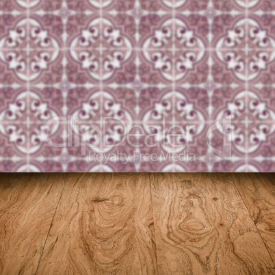 Wood table top and blur vintage ceramic tile pattern wall Wood table top and blur vintage ceramic tile pattern wall