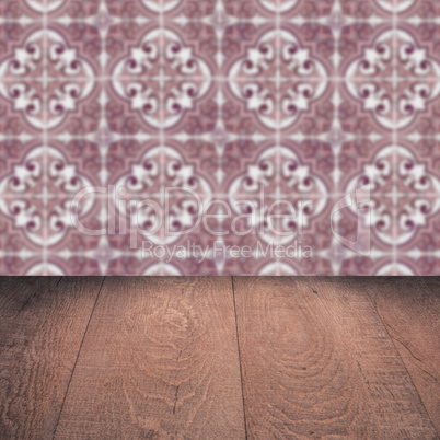 Wood table top and blur vintage ceramic tile pattern wall Wood table top and blur vintage ceramic tile pattern wall