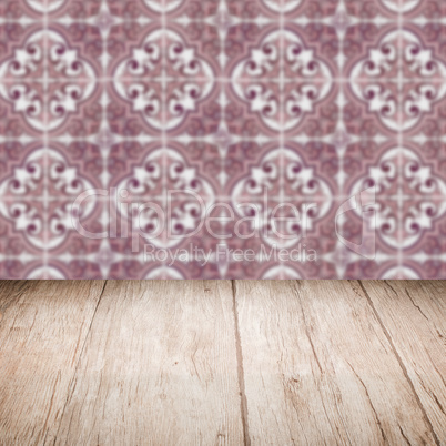 Wood table top and blur vintage ceramic tile pattern wall