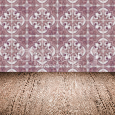 Wood table top and blur vintage ceramic tile pattern wall