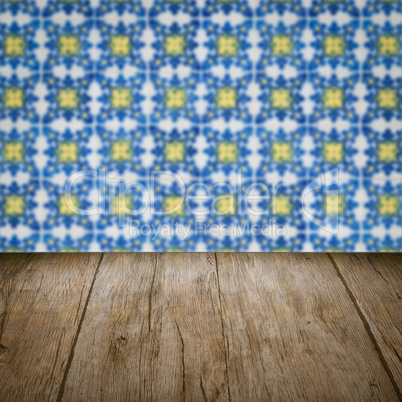 Wood table top and blur vintage ceramic tile pattern wall