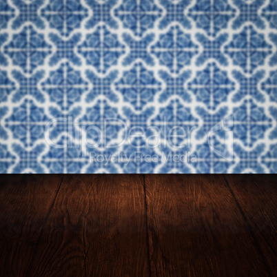 Wood table top and blur vintage ceramic tile pattern wall