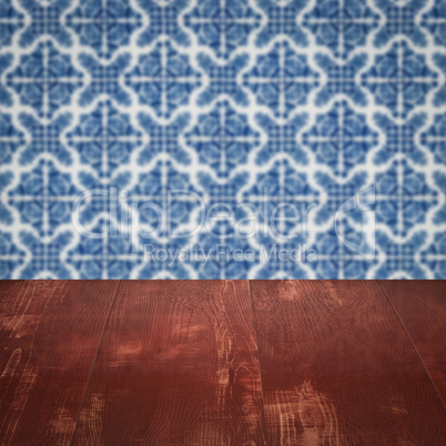 Wood table top and blur vintage ceramic tile pattern wall