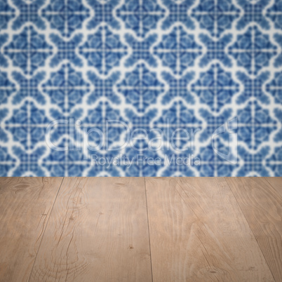 Wood table top and blur vintage ceramic tile pattern wall Wood table top and blur vintage ceramic tile pattern wall