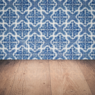 Wood table top and blur vintage ceramic tile pattern wall