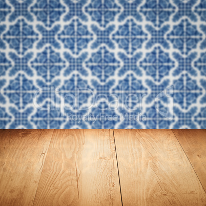 Wood table top and blur vintage ceramic tile pattern wall