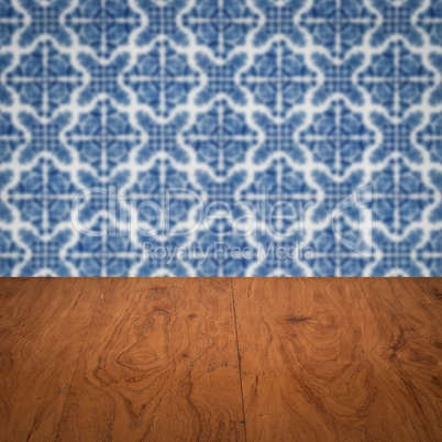 Wood table top and blur vintage ceramic tile pattern wall