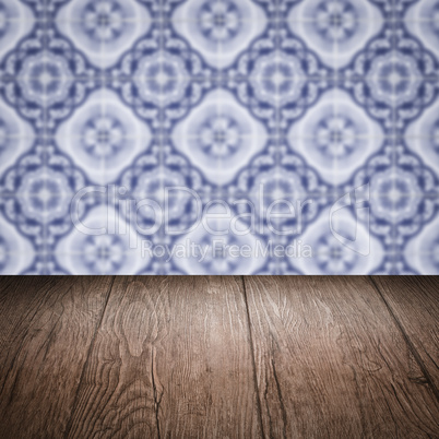 Wood table top and blur vintage ceramic tile pattern wall