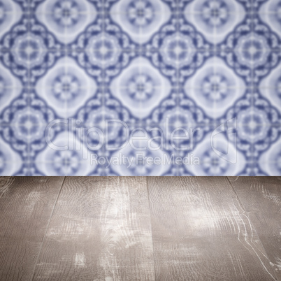 Wood table top and blur vintage ceramic tile pattern wall