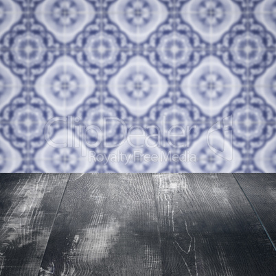 Wood table top and blur vintage ceramic tile pattern wall