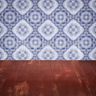 Wood table top and blur vintage ceramic tile pattern wall