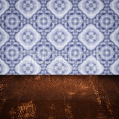 Wood table top and blur vintage ceramic tile pattern wall