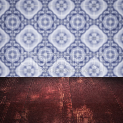 Wood table top and blur vintage ceramic tile pattern wall