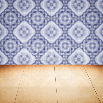 Wood table top and blur vintage ceramic tile pattern wall