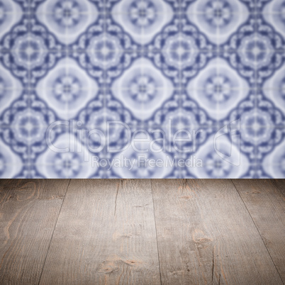 Wood table top and blur vintage ceramic tile pattern wall