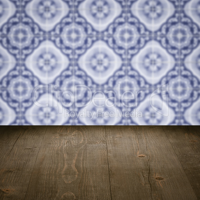 Wood table top and blur vintage ceramic tile pattern wall Wood table top and blur vintage ceramic tile pattern wall