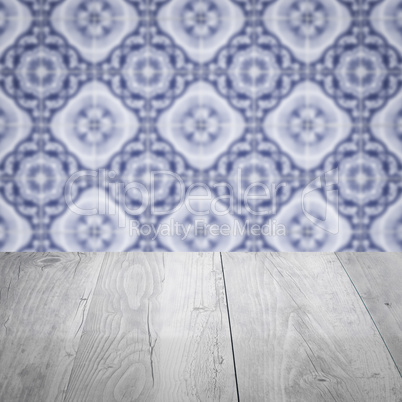 Wood table top and blur vintage ceramic tile pattern wall