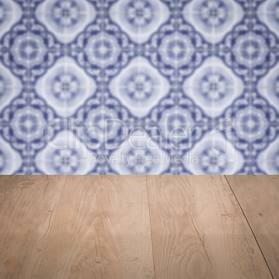 Wood table top and blur vintage ceramic tile pattern wall