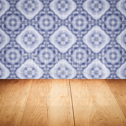 Wood table top and blur vintage ceramic tile pattern wall