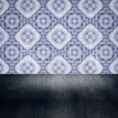 Wood table top and blur vintage ceramic tile pattern wall Wood table top and blur vintage ceramic tile pattern wall