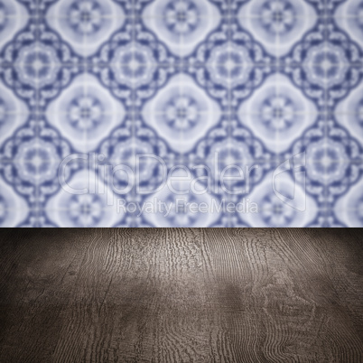 Wood table top and blur vintage ceramic tile pattern wall