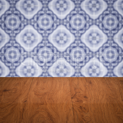 Wood table top and blur vintage ceramic tile pattern wall